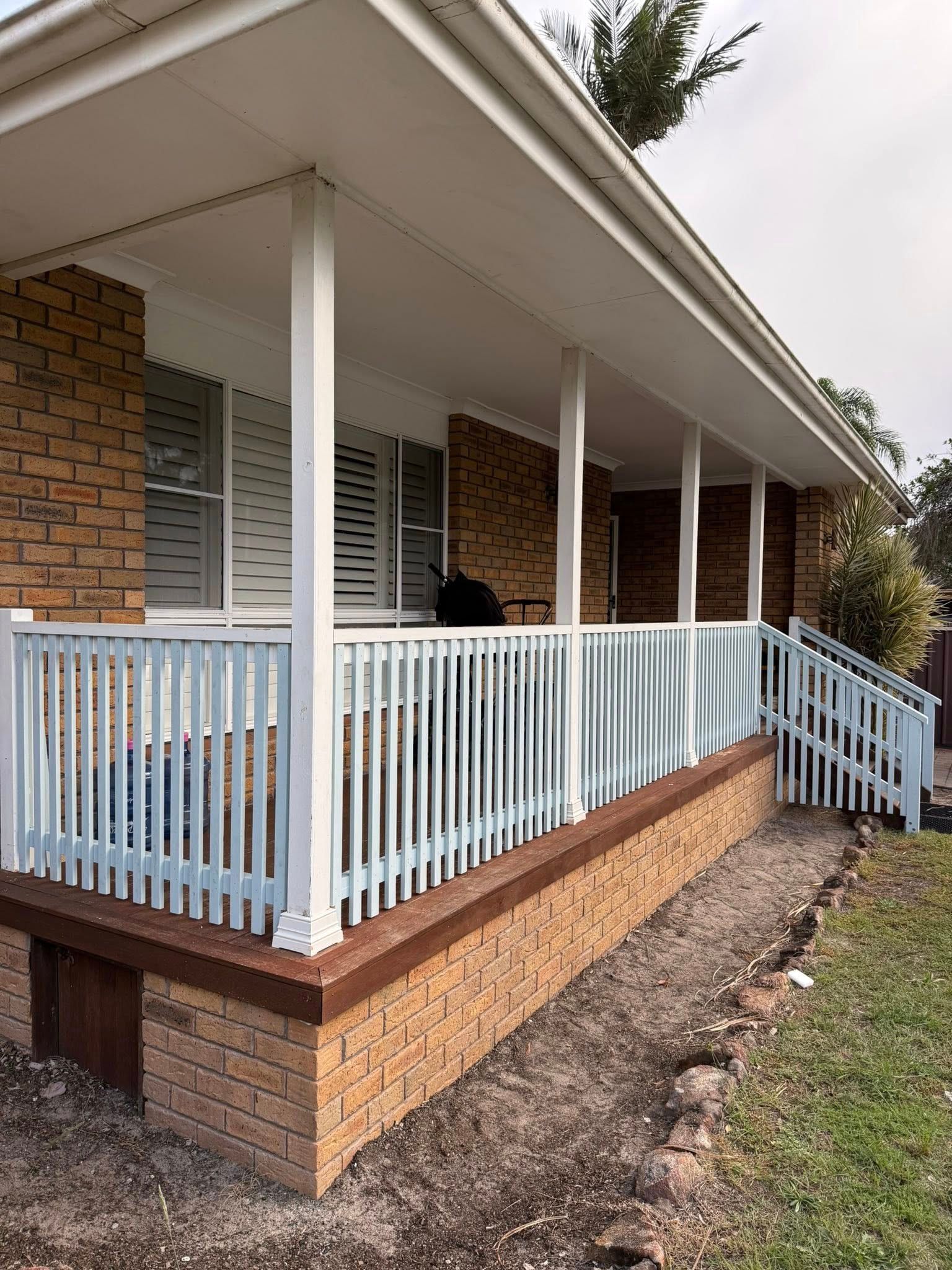 Brick House Porch With White Railings — Tyrone Building Solutions in Anna Bay, NSW