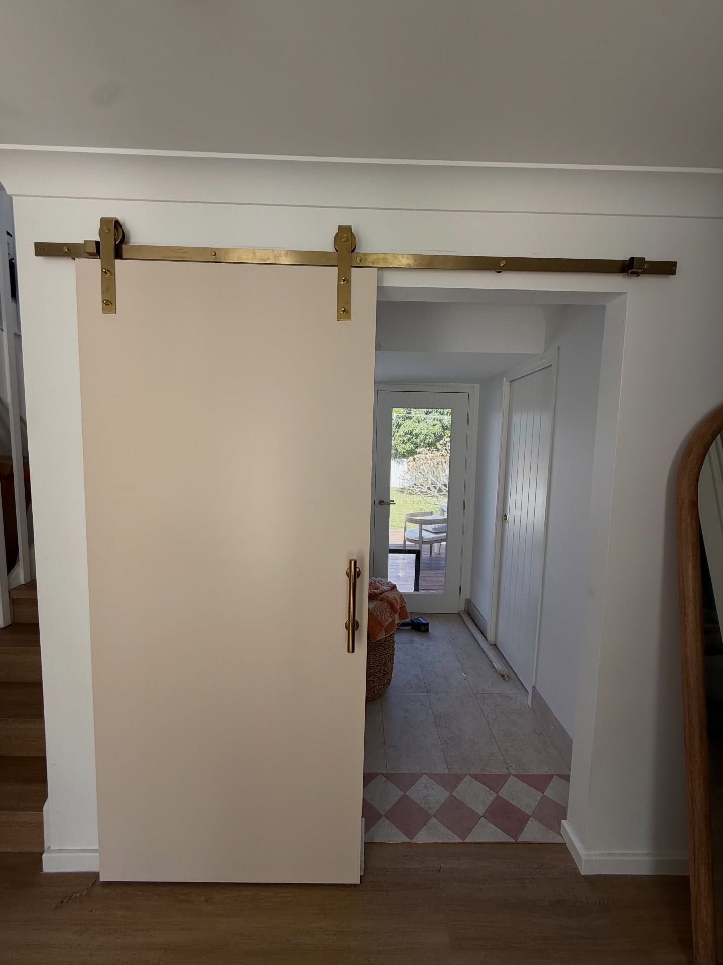Sliding Barn Door on a Brass Track in a Room — Tyrone Building Solutions in Anna Bay, NSW