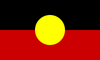A red , black and yellow flag with a yellow circle in the middle.