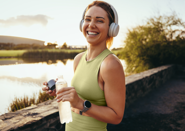 woman with headphones and water bottle 