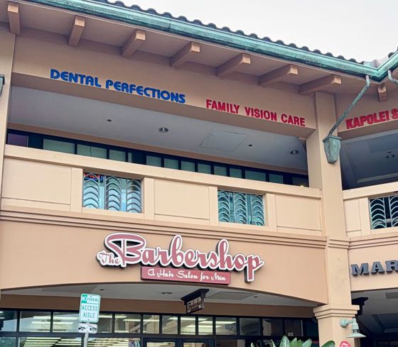 Strip mall storefront with “Sunblowshop” sign beneath dental and family vision care offices.