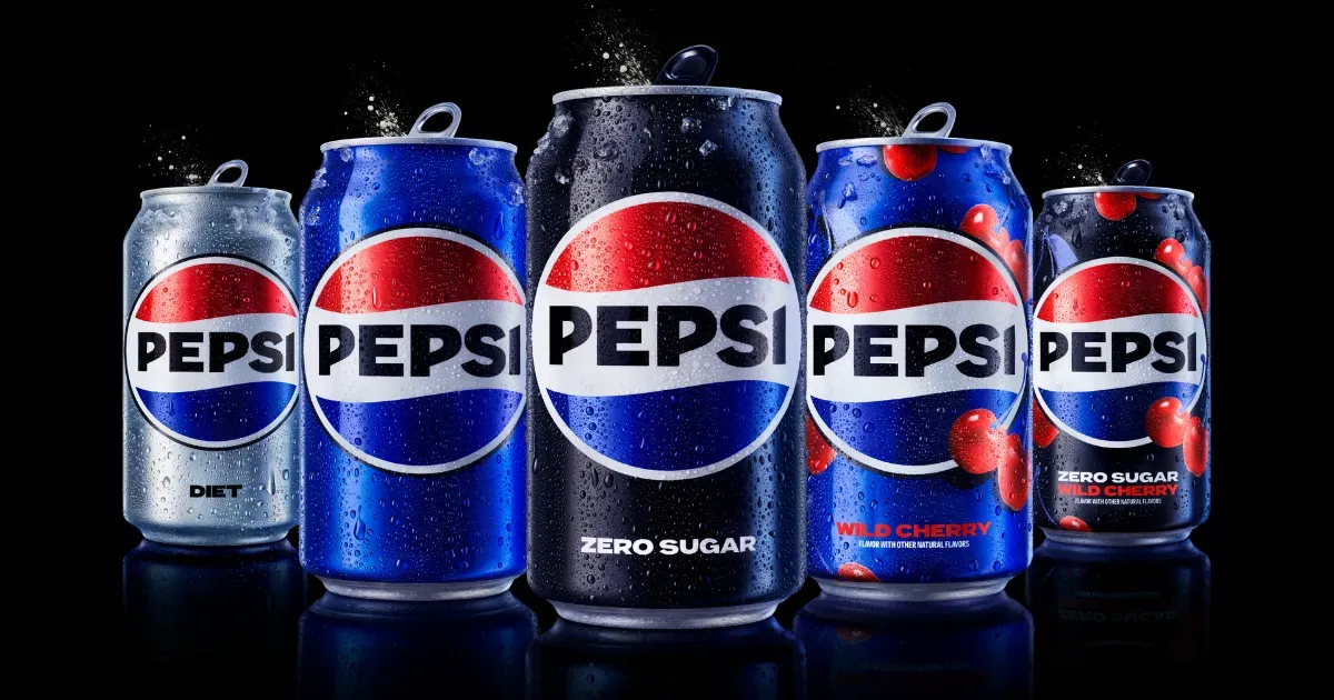Several cans of pepsi are lined up in a row
