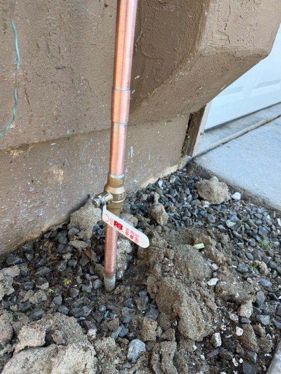 Yellow-handled valve on white and gray pipes, with blue valve body.