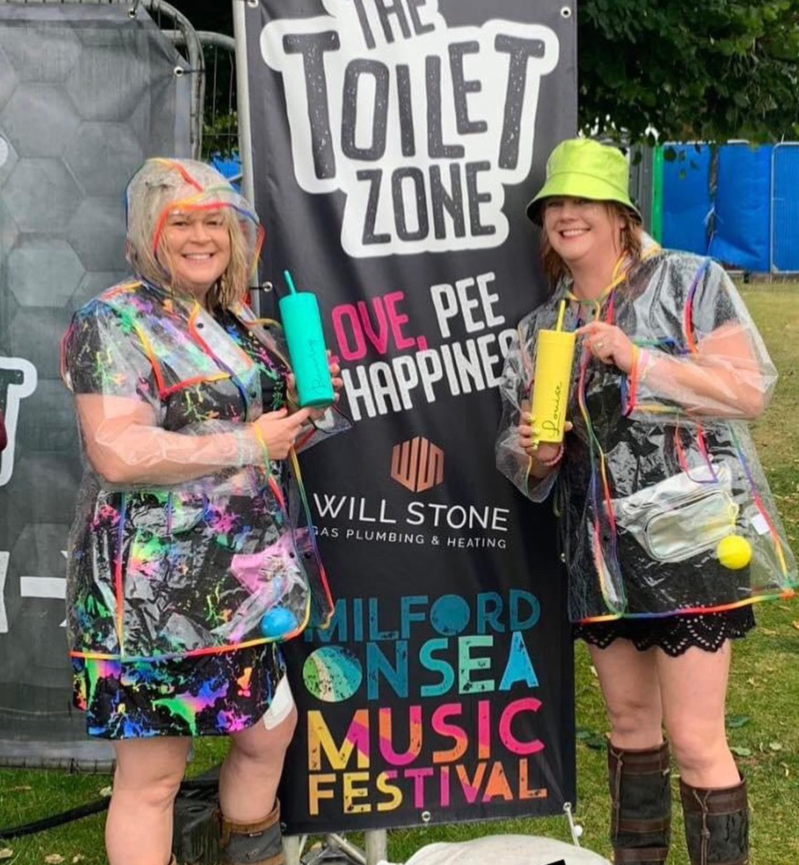 Two women at a music festival stand by 
