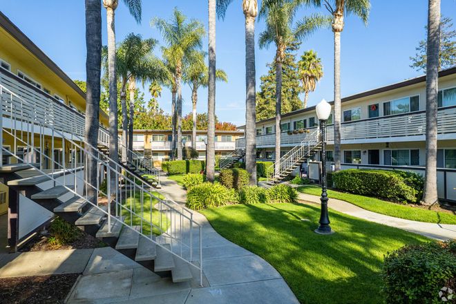 A staircase leading up to a building with palm trees in the background