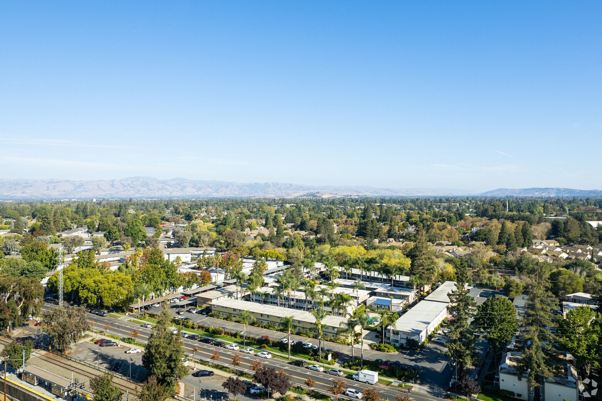 An aerial view of a residential area with lots of trees and buildings.