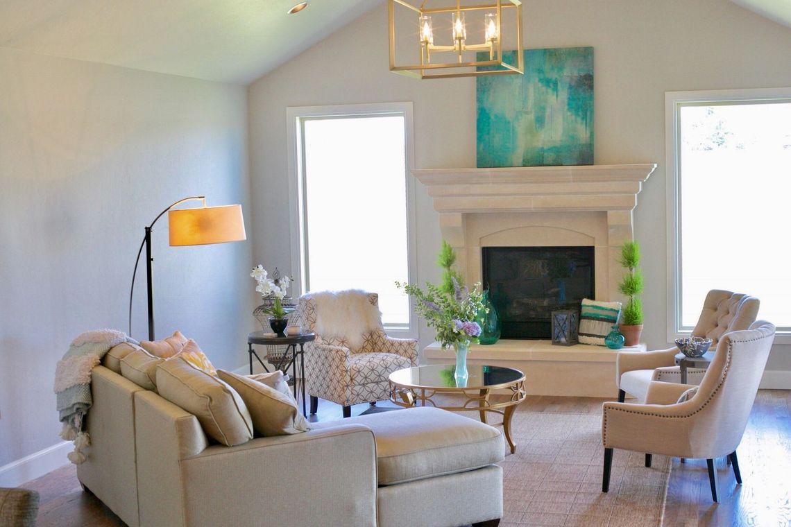 A bedroom with a large bed , dresser , nightstands , and a rug.