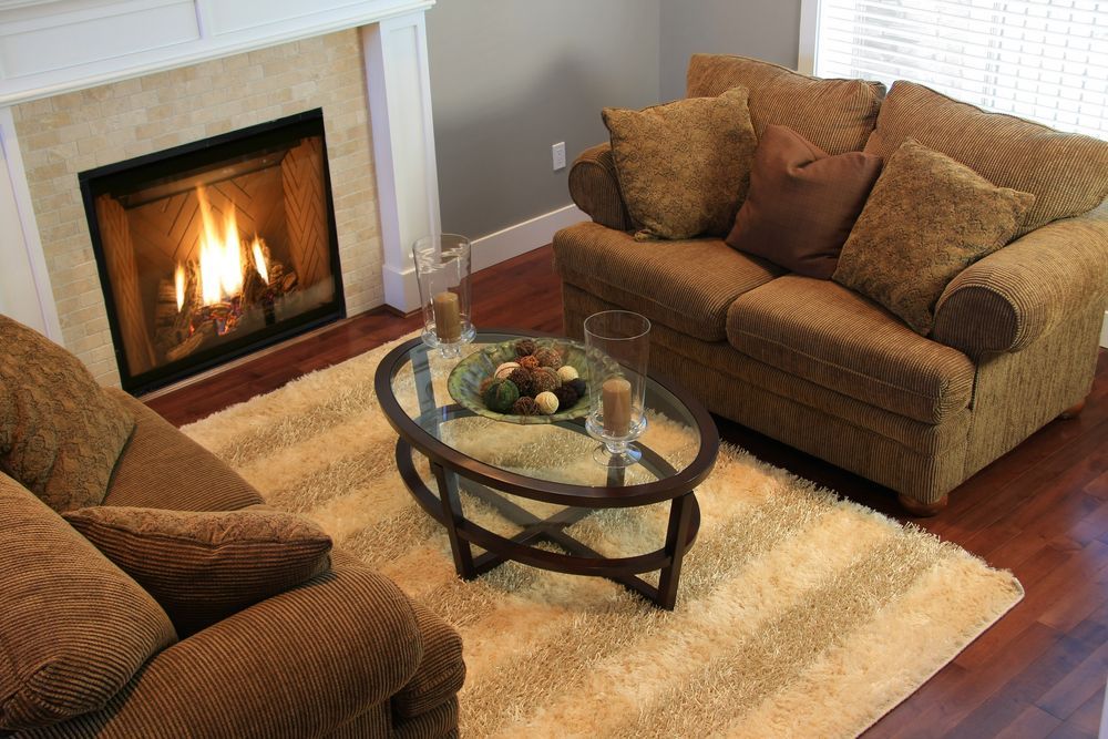 A Living Room Featuring a Lit Fireplace — Complete Heating In Huntingfield, TAS
