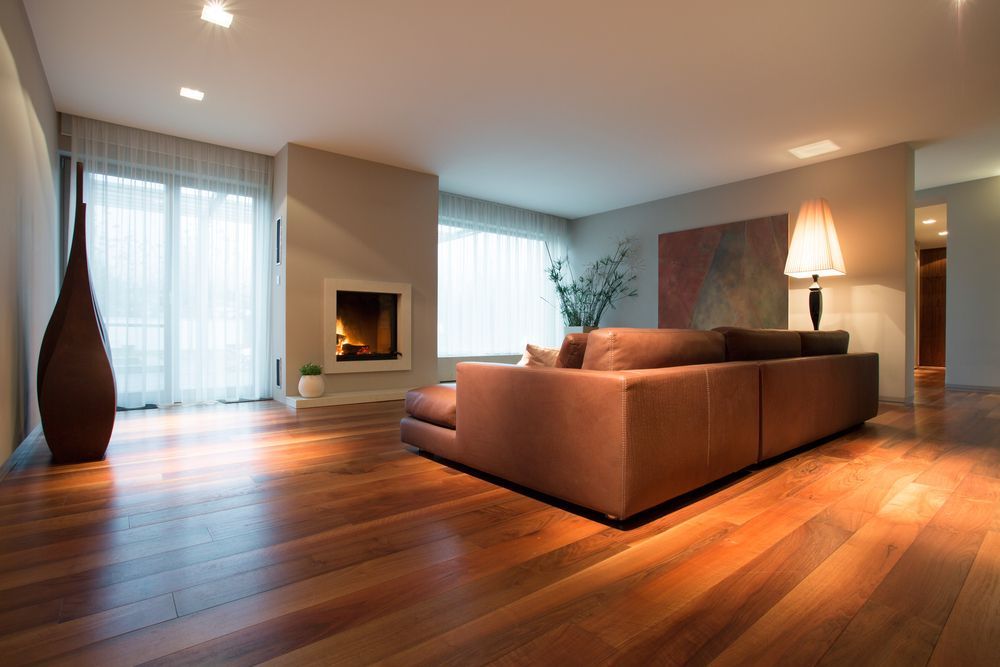A Modern Living Room With a Fireplace and a Floor Lamp — Complete Heating In Huntingfield, TAS