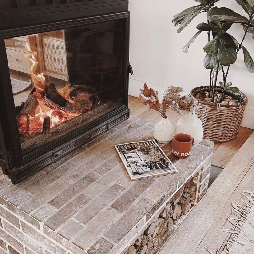 A Lit Fireplace Sits Atop a Brick Hearth — Complete Heating In Huntingfield, TAS