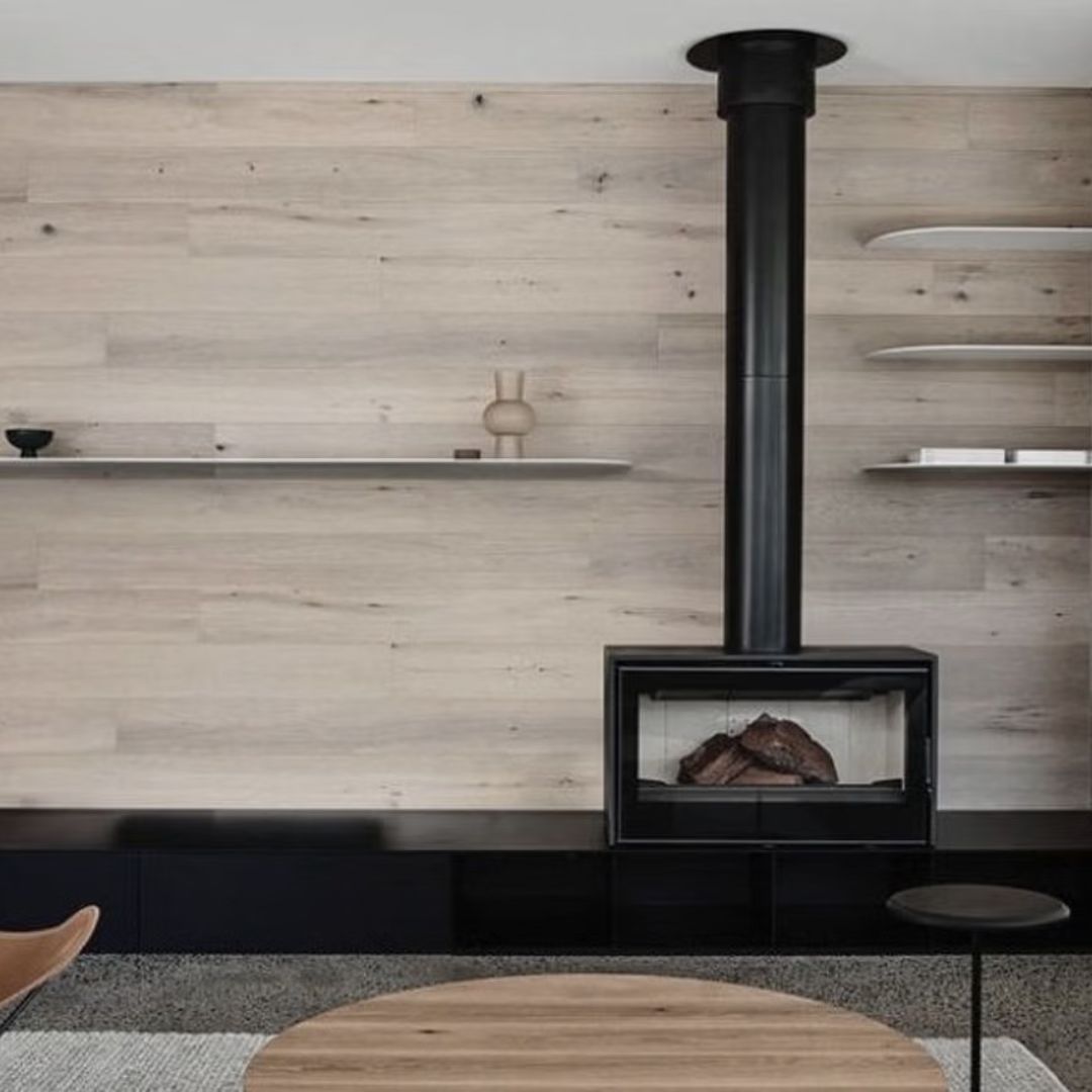 A Modern Living Room Featuring a Black Fireplace With a Vertical Flue — Complete Heating In Huntingfield, TAS