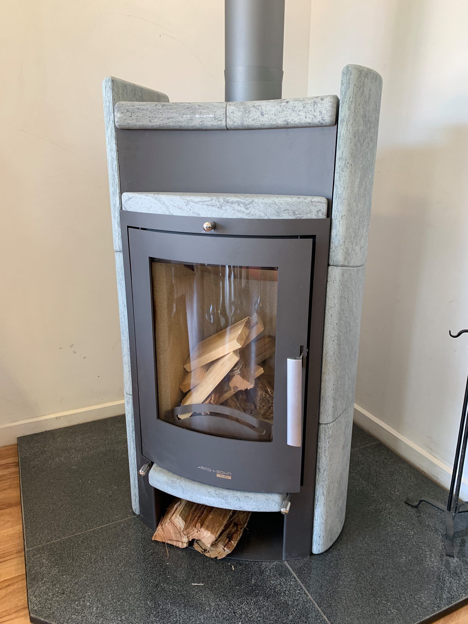 A Wood-burning Stove With a Glass Door and Stone Cladding — Complete Heating In Hobart, TAS