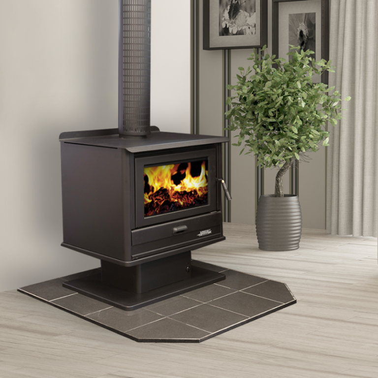 Wood-burning Stove on a Tiled Mat Beside a Potted Plant in a Bright Room — Complete Heating In Huntingfield, TAS