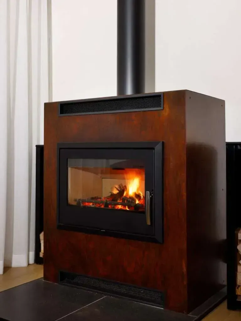 Wood-burning Stove With a Fire Burning Inside — Complete Heating In Huntingfield, TAS