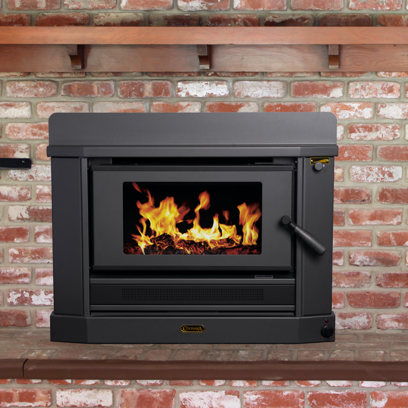 Black Wood-burning Stove With a Fire Burning Inside Against a Brick Wall — Complete Heating In Huntingfield, TAS
