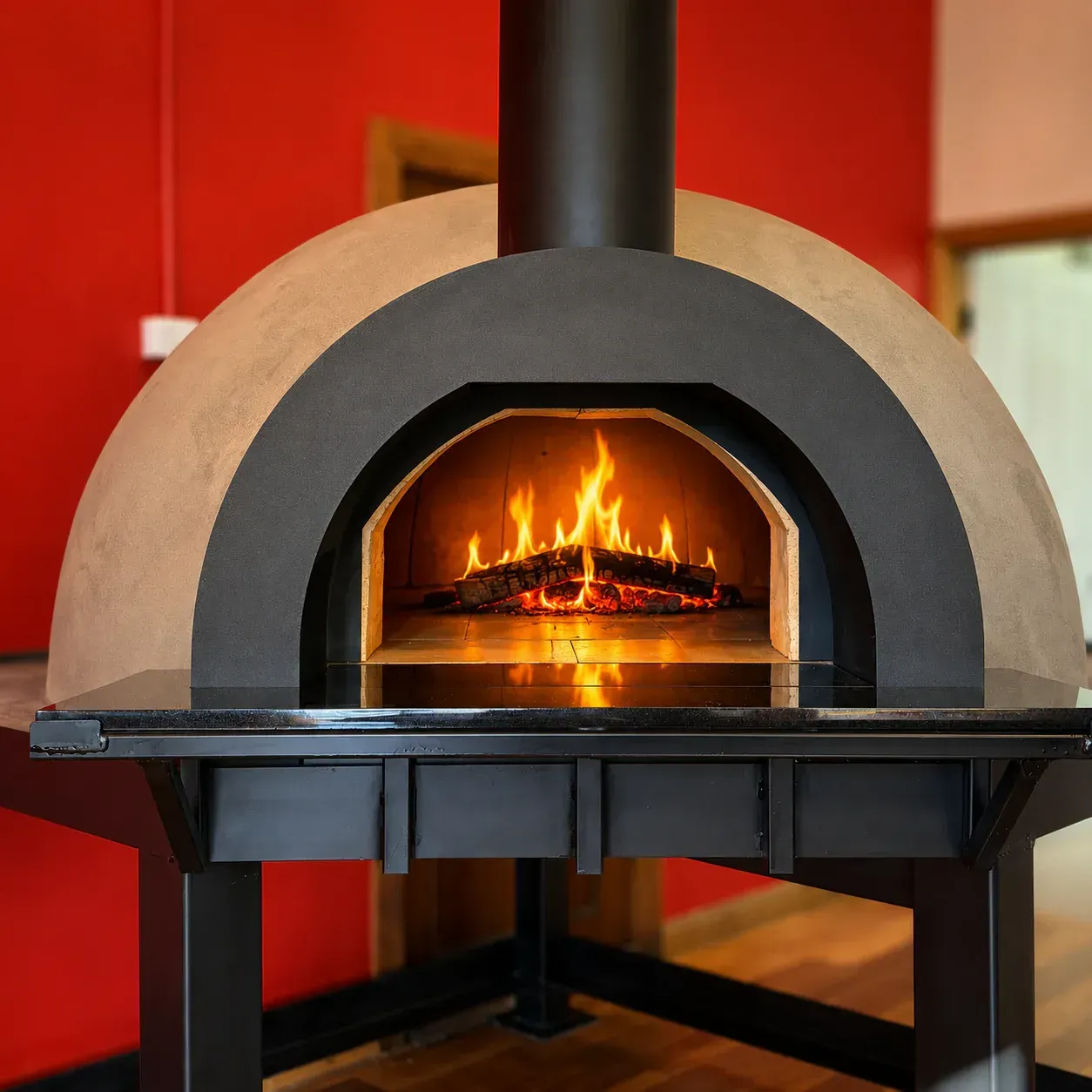 Modern Wood-fired Oven With Flames Burning Inside, Set Against a Red Wall — Complete Heating In Huntingfield, TAS