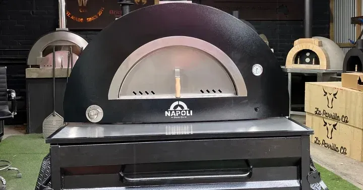 Black Dome Pizza Oven With Arched Opening in a Kitchen Showroom — Complete Heating In Huntingfield, TAS