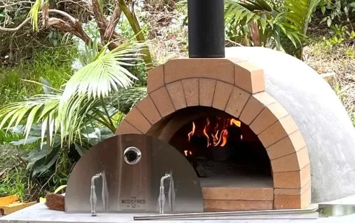 Brick Wood-fired Outdoor Oven With Burning Fire — Complete Heating In Huntingfield, TAS