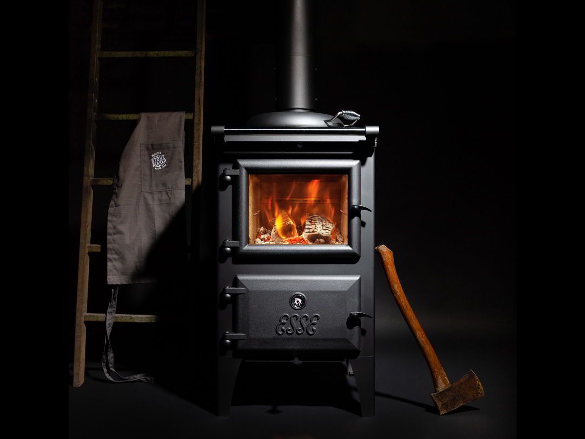 Black Wood Stove With Visible Fire — Complete Heating In Huntingfield, TAS