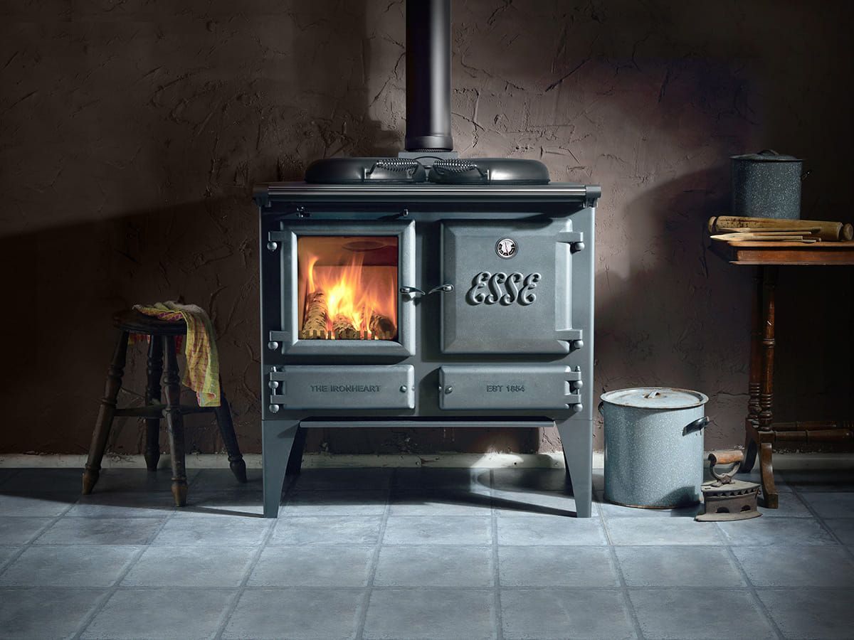 Wood-burning Stove With Glowing Fire in a Rustic Room — Complete Heating In Huntingfield, TAS