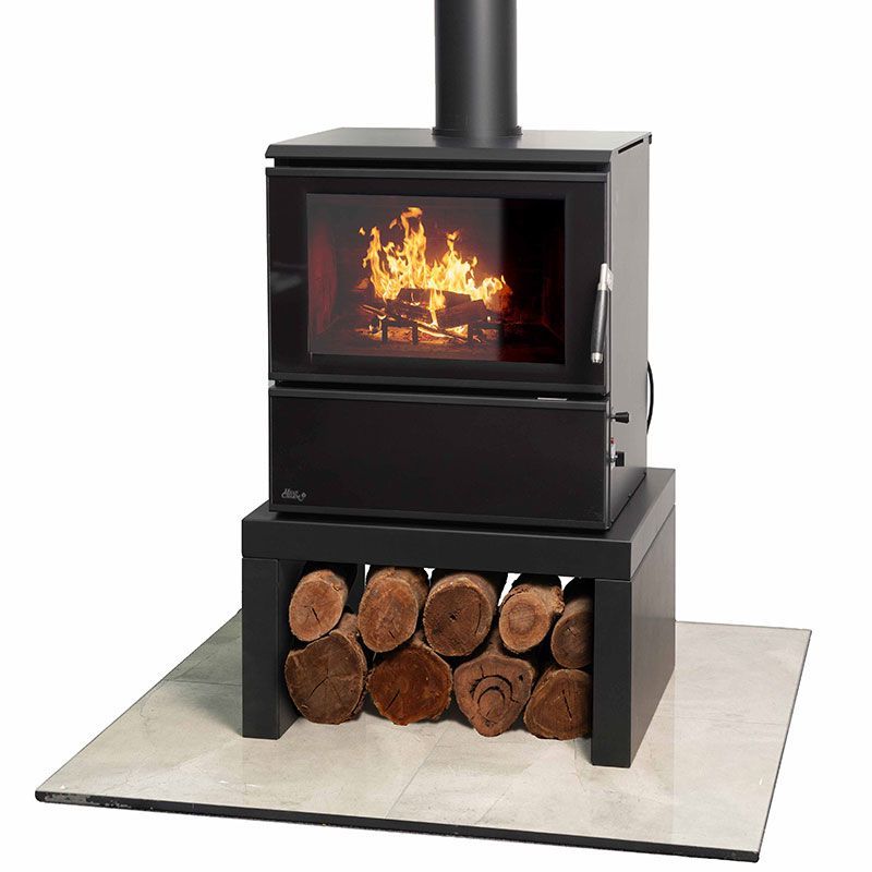 Wood-burning Stove With Visible Fire, Chimney Pipe, and Logs Stored Below on a Tiled Hearth — Complete Heating In Huntingfield, TAS