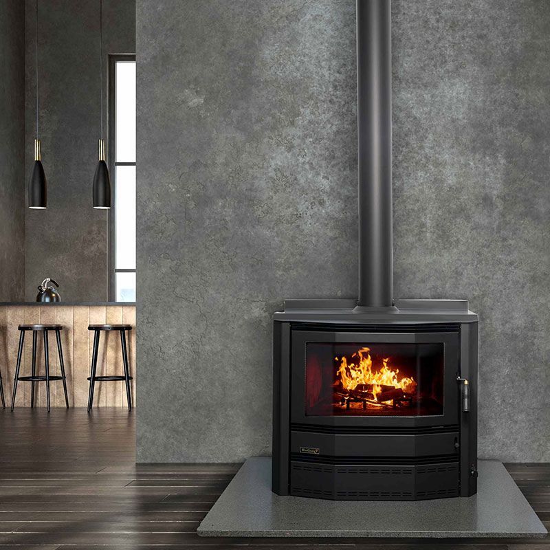 Modern Living Room With a Black Wood Stove Burning — Complete Heating In Huntingfield, TAS