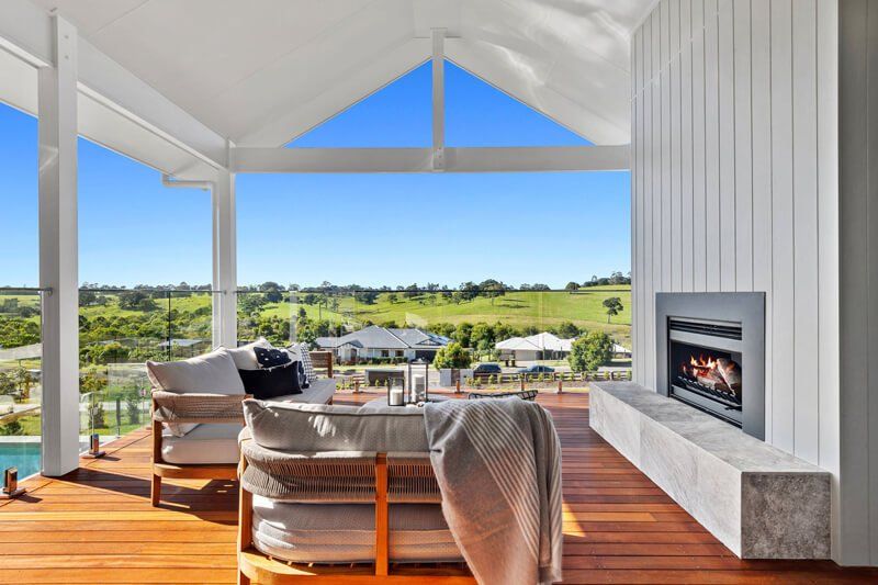 Covered Patio With Wicker Seating and Fireplace — Complete Heating In Huntingfield, TAS