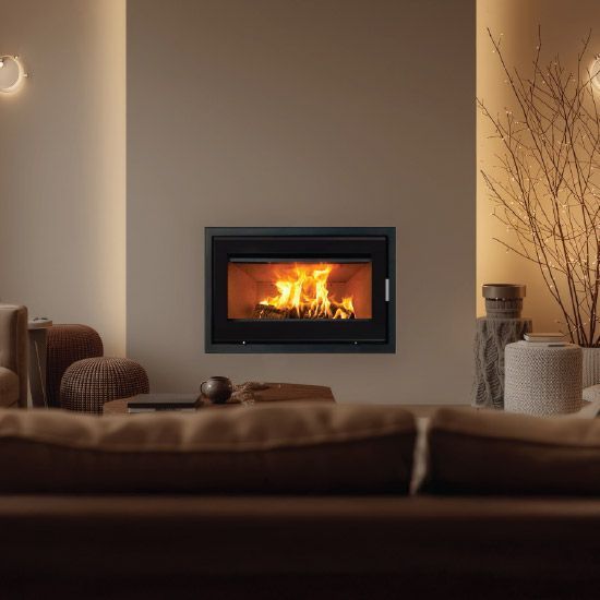 Cozy Living Room With a Lit Fireplace, Warm Beige Walls, and Soft Seating — Complete Heating In Huntingfield, TAS