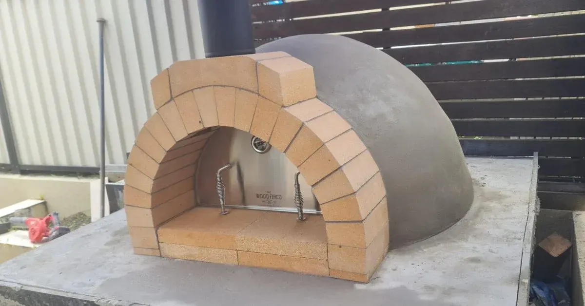 Partially Built Brick Pizza Oven With Gray Dome on a Concrete BASE in a Workshop — Complete Heating In Huntingfield, TAS
