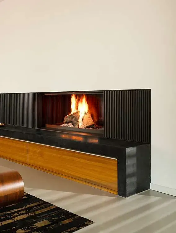 Fireplace With Burning Logs, Black Surround, and Wooden Base — Complete Heating In Huntingfield, TAS
