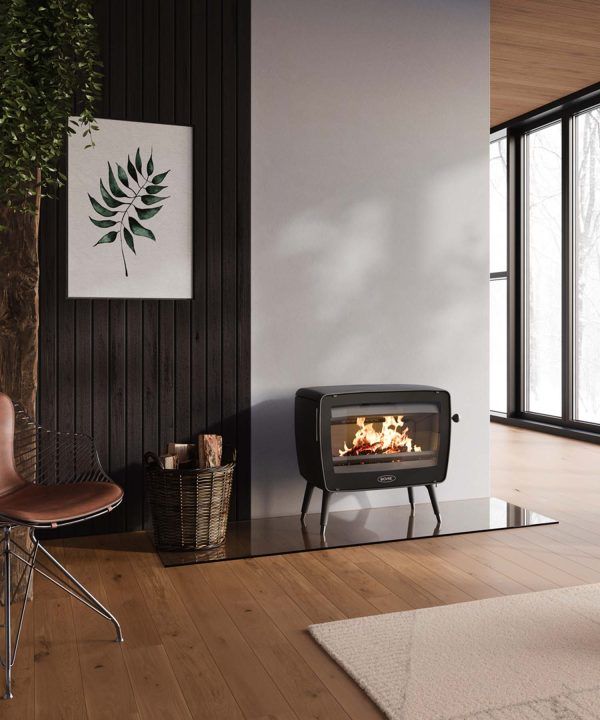 Cozy Living Room With a Black Fireplace and Wood-paneled Wall — Complete Heating In Huntingfield, TAS