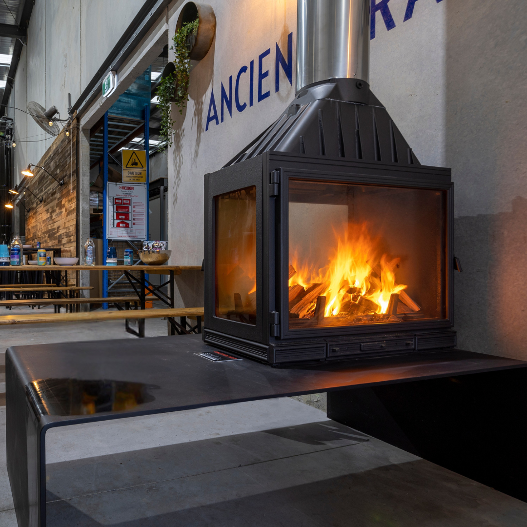 Black Metal Fireplace With Flames on a Restaurant Patio — Complete Heating In Huntingfield, TAS