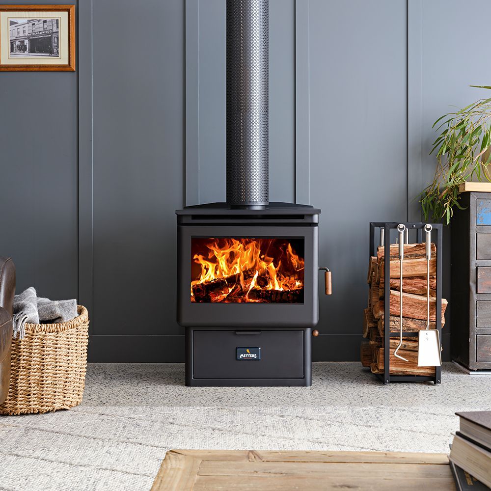 Black Wood-burning Stove With Visible Flames in a Grey-paneled Room — Complete Heating In Huntingfield, TAS