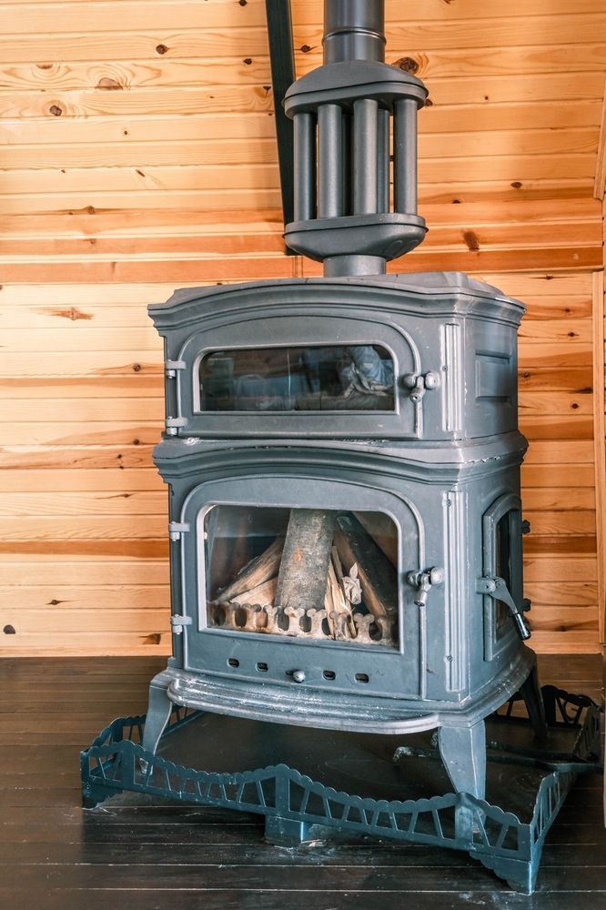 A Cast-iron Wood-burning Stove With a Glass Door — Complete Heating In Huntingfield, TAS