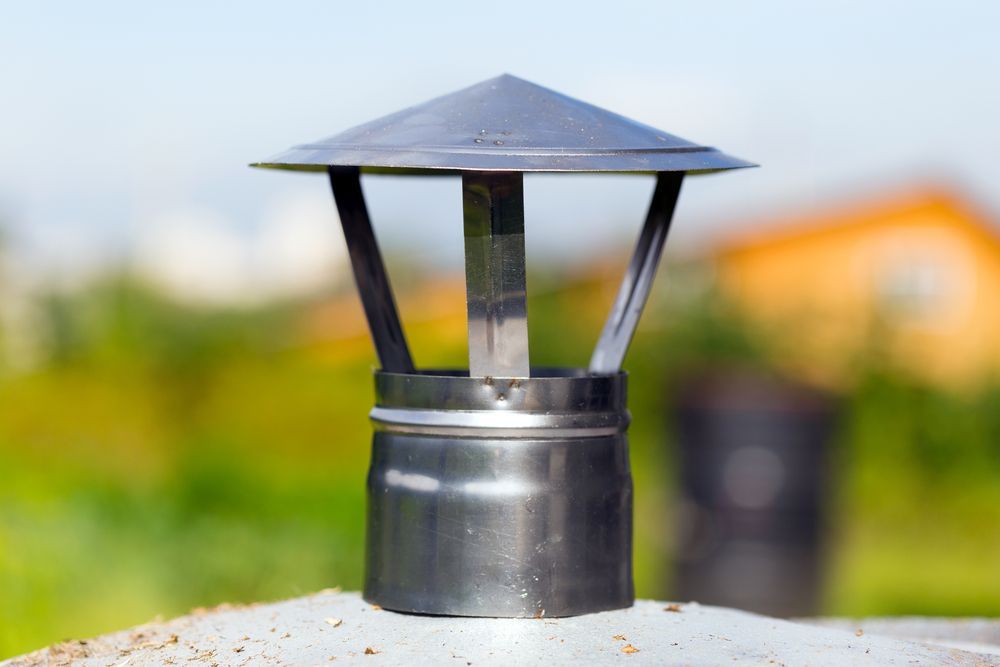 A Metal Chimney Cap Sits Atop a Flue — Complete Heating In Huntingfield, TAS