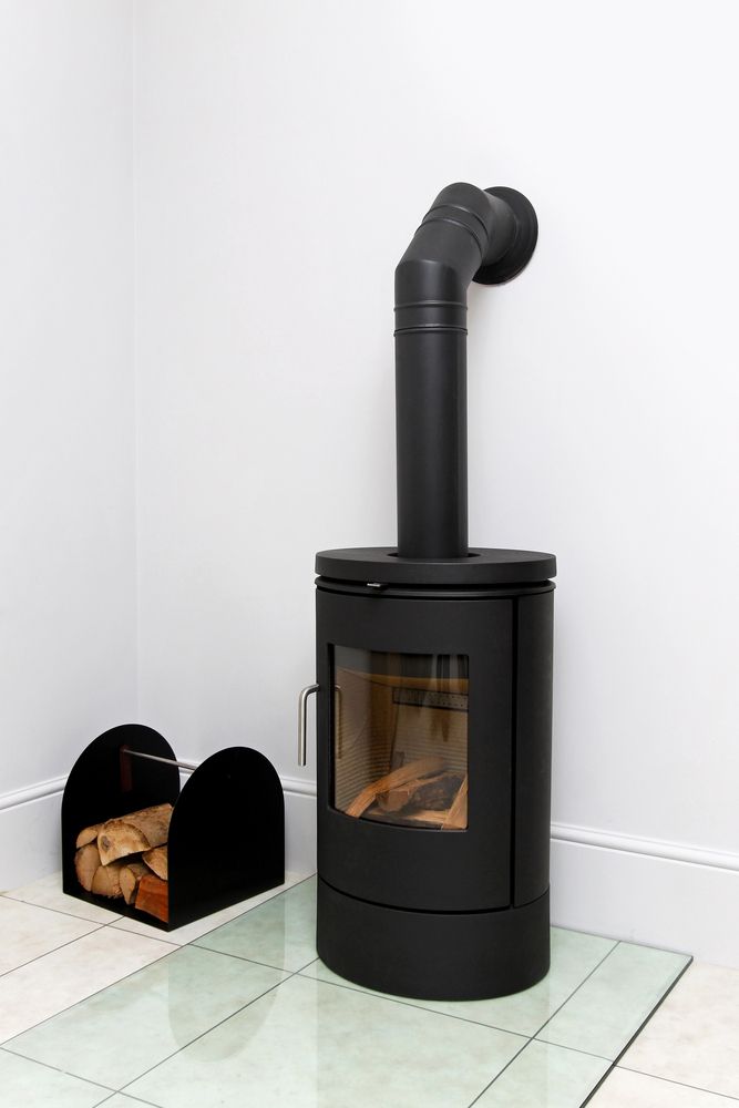 A Black Wood-burning Stove With a Chimney Pipe — Complete Heating In Huntingfield, TAS