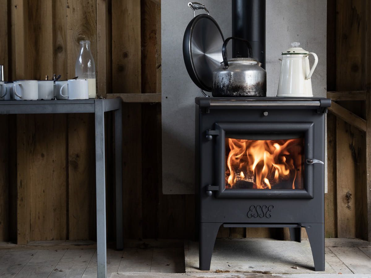 Wood-burning Stove With a Bright Fire in a Rustic Room — Complete Heating In Huntingfield, TAS
