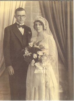 Vintage sepia wedding portrait of a bride and groom standing together in formal attire