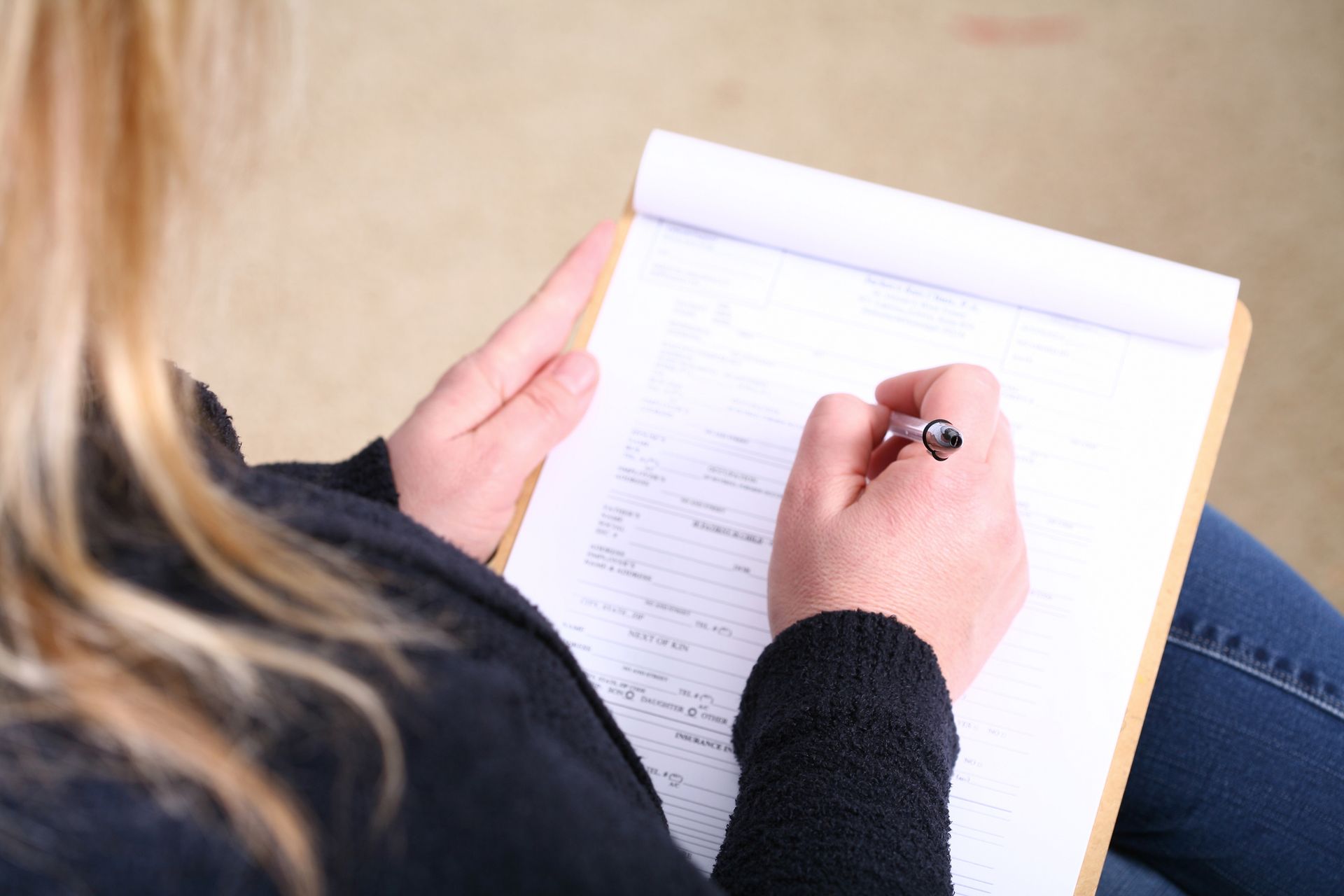 A Patient Filling Out A Form — Anniston, AL — Bolton Chiropractic