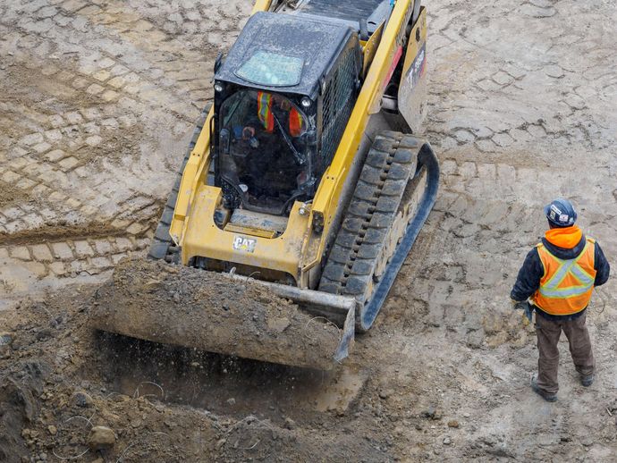 skid steer grading land for site preparation in pemberton