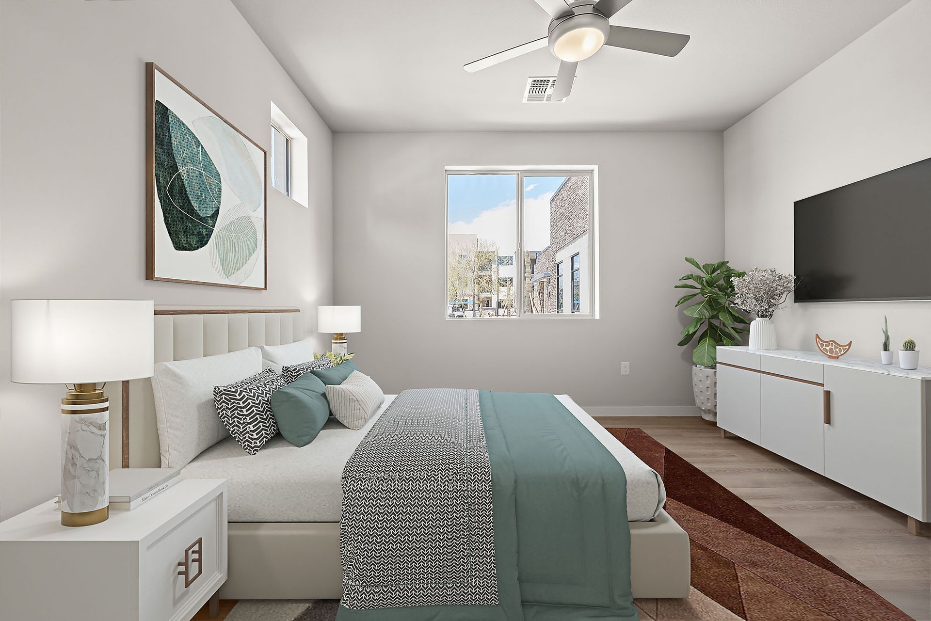 A bedroom with a bed , nightstand , television and ceiling fan.