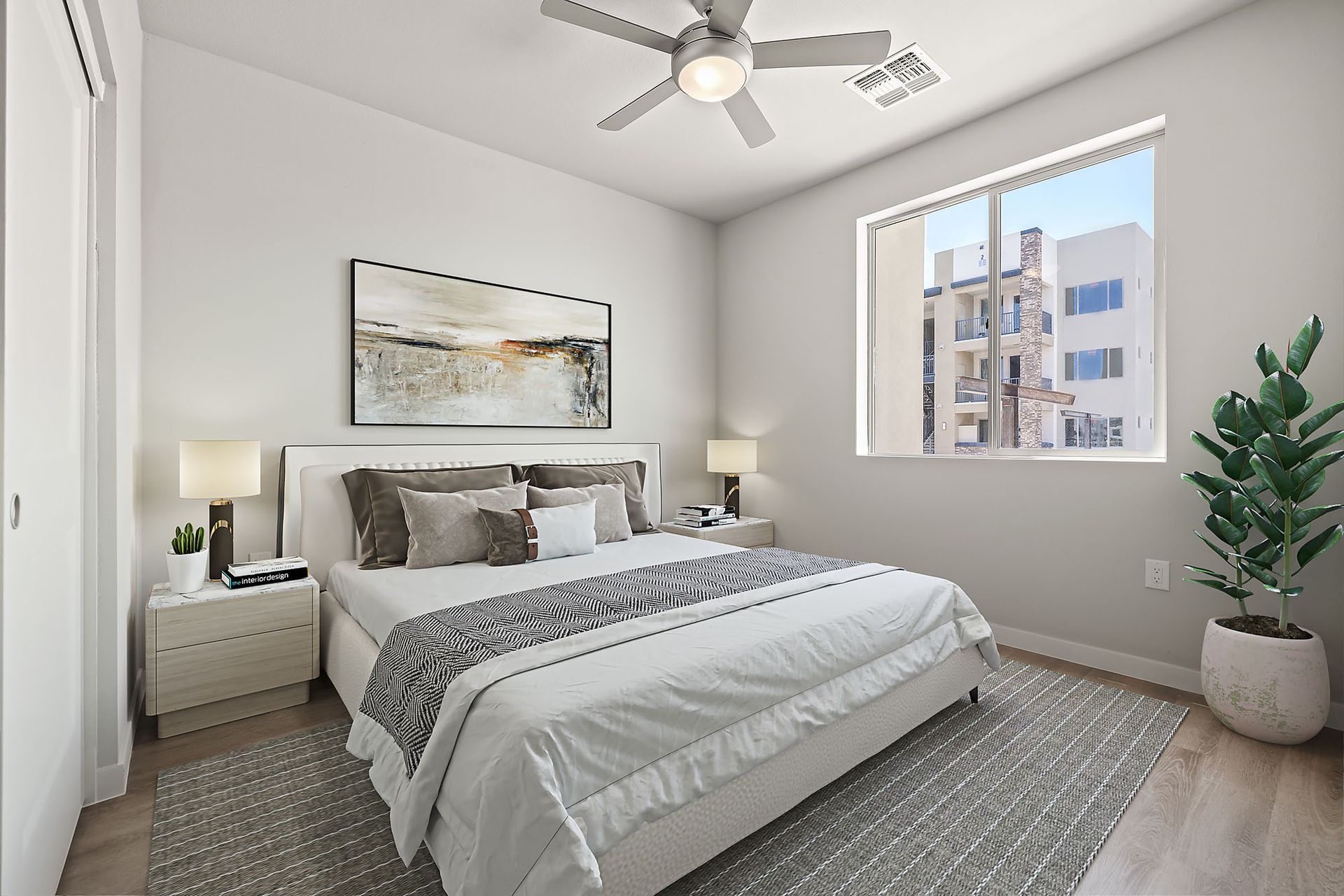 A bedroom with a large bed and a ceiling fan.