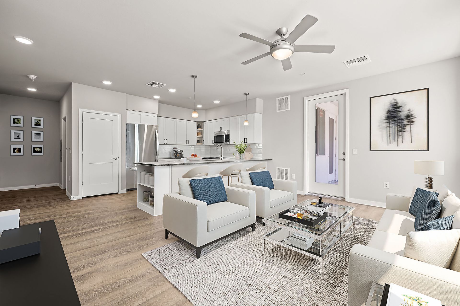 A living room filled with furniture and a ceiling fan.