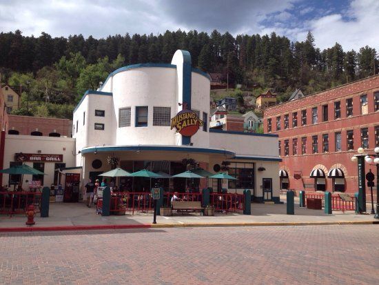 A large white building with a sign that says ' cafe lane ' on it