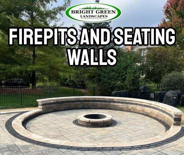 Firepit and seating wall built in a yard by Bright Green Landscapes.