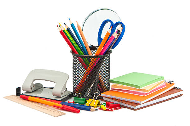 A pencil holder filled with colored pencils and scissors