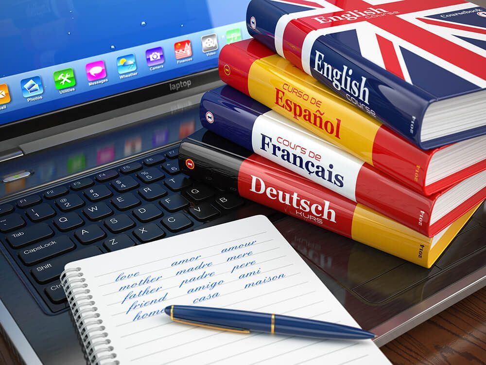 A stack of books including english spanish and french