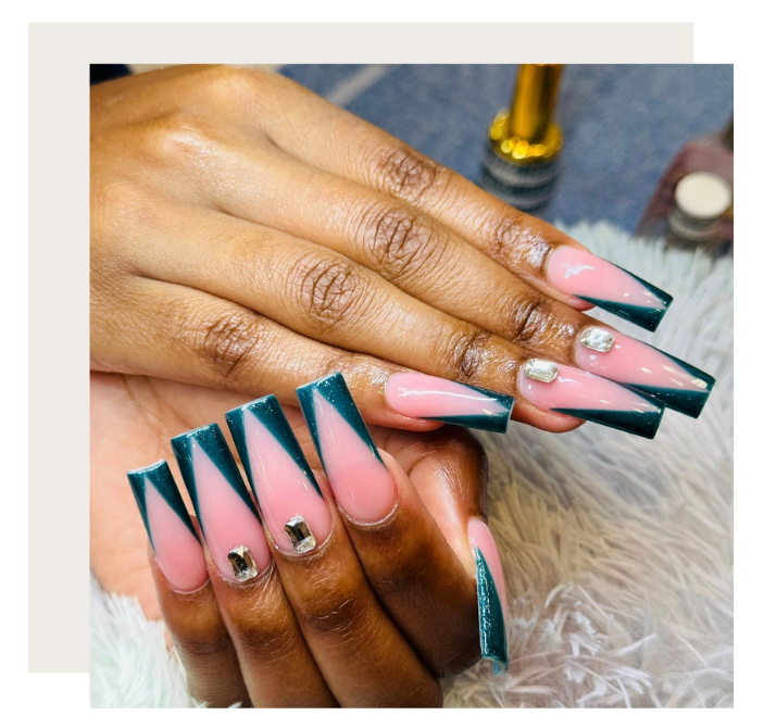 Long, square-tipped nails featuring a pink V-shape French manicure design in deep teal with small decorative rhinestones.