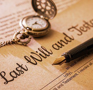 A fountain pen is sitting on top of a last will and testament.