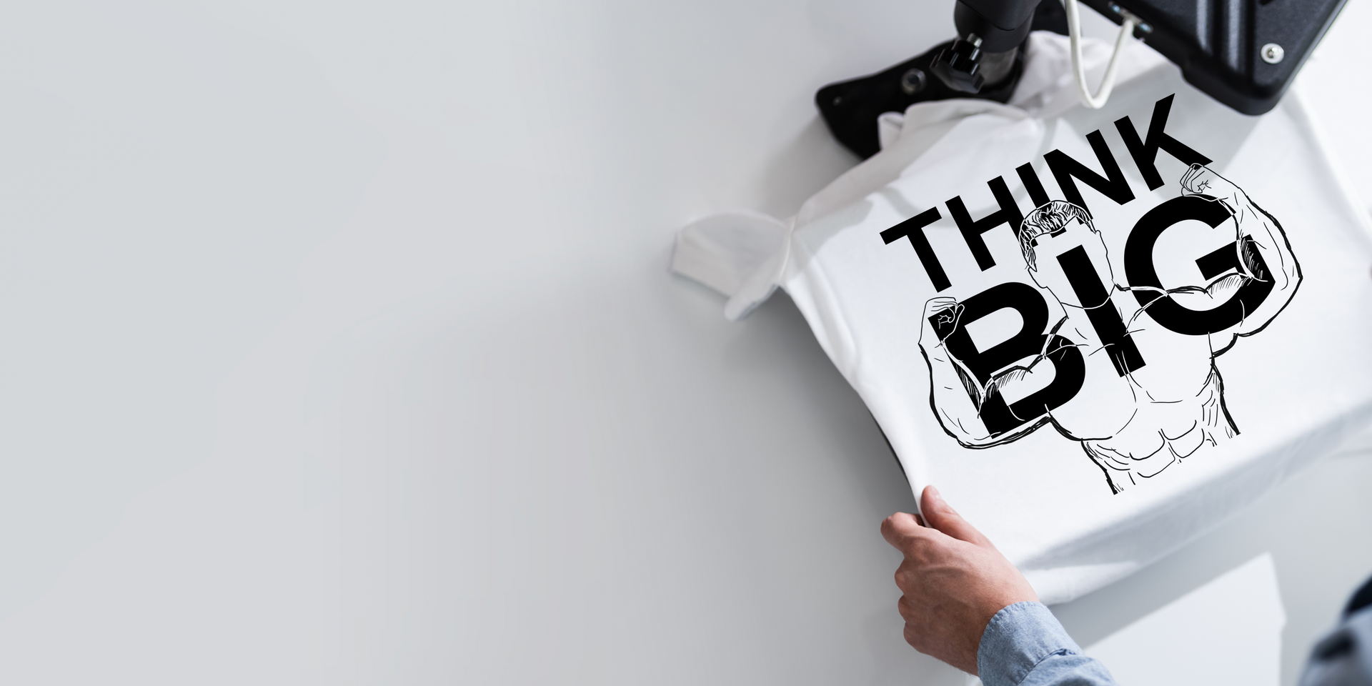 A person holding a white t-shirt with the words 